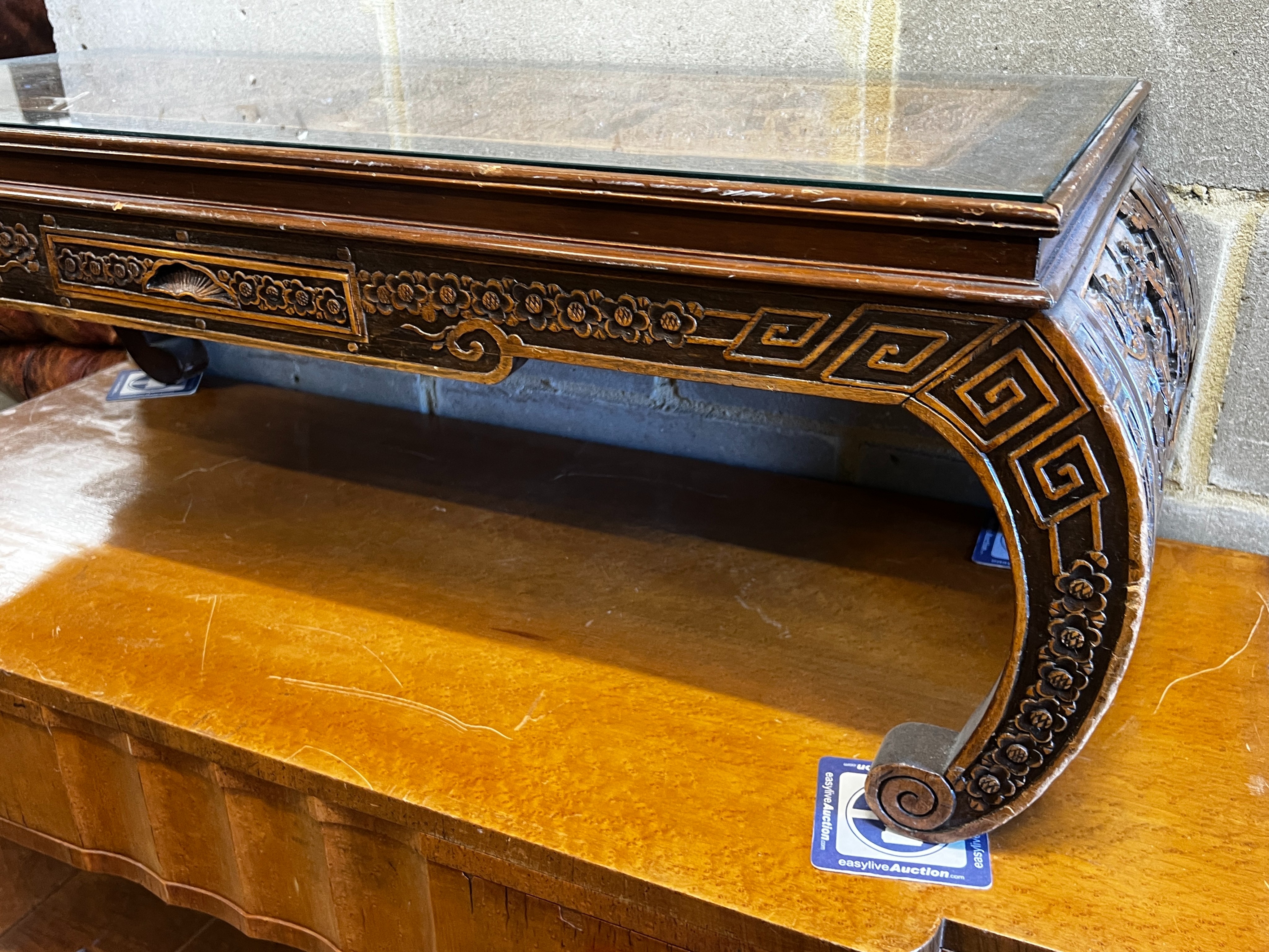 A Chinese carved hardwood low table, length 110cm, depth 43cm, height 36cm